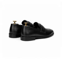 Black penny loafer, angled view