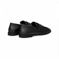 Black slip-on loafer, angled view