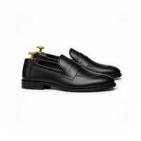 Black penny loafer, top-down view