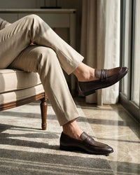Dark brown penny loafer styled shot